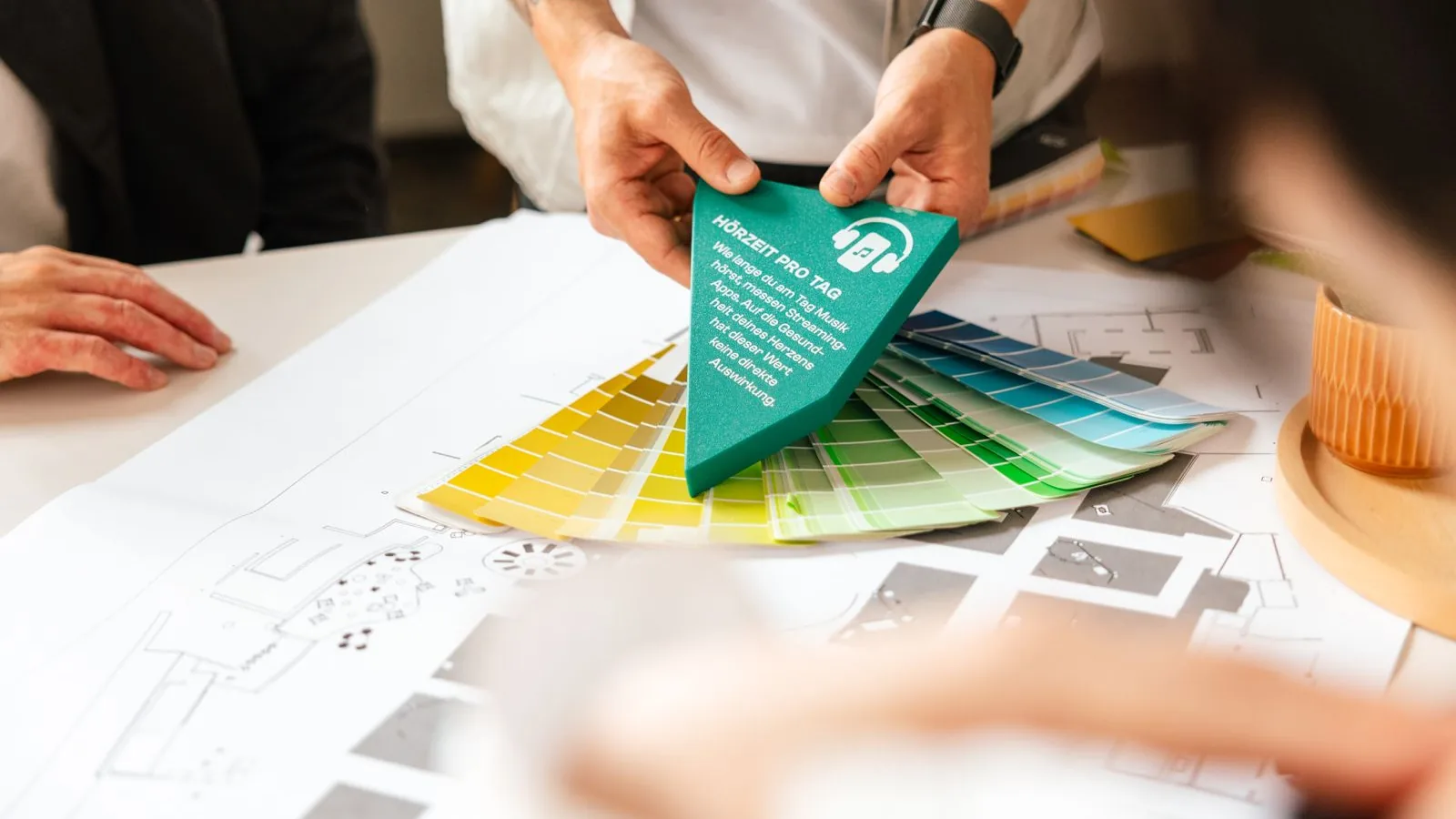 Colour fan and exhibit model over exhibition plans at the ping studio